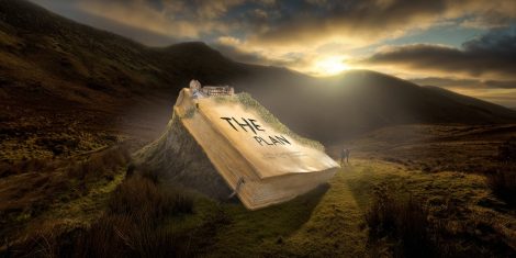 A large book on a welsh mountainside with "The Plan" written on it.